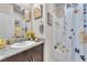 Well-lit bathroom with granite vanity, mirror, and a shower-tub combination at 4725 Blaise Ave # 103, North Las Vegas, NV 89084