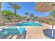 Community pool with lounge chairs and umbrellas provides a resort-style experience at 4725 Blaise Ave # 103, North Las Vegas, NV 89084