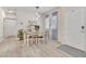 Inviting dining area with wood table, white chairs, and natural light from the window at 4725 Blaise Ave # 103, North Las Vegas, NV 89084