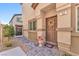 Inviting home entrance with decorative wreath, flower pot, and brick pathway at 4725 Blaise Ave # 103, North Las Vegas, NV 89084