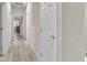 Bright hallway with modern flooring, white walls, and doors leading to various rooms at 4725 Blaise Ave # 103, North Las Vegas, NV 89084