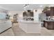 Bright kitchen featuring a granite island, stainless appliances, and stylish wood flooring at 4725 Blaise Ave # 103, North Las Vegas, NV 89084