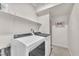 Clean laundry room featuring modern washer and dryer units with shelving and decor at 4725 Blaise Ave # 103, North Las Vegas, NV 89084