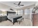 Serene main bedroom with a dark wood bed frame, neutral walls, and ample natural light at 4725 Blaise Ave # 103, North Las Vegas, NV 89084