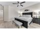 Cozy main bedroom with a dark wood bed frame and light wood flooring at 4725 Blaise Ave # 103, North Las Vegas, NV 89084