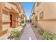 Charming walkway lined with lush landscaping between two residential buildings at 4725 Blaise Ave # 103, North Las Vegas, NV 89084