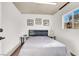 A simple bedroom features neutral tones, offering a blank canvas for personalization at 5005 Harmony Ave, Las Vegas, NV 89107