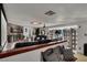 Cozy living room with fireplace, dark leather couches, and decorative room divider at 5005 Harmony Ave, Las Vegas, NV 89107