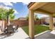Inviting backyard patio with a dining table, chairs, and artificial grass at 5023 Salt River Ave, Las Vegas, NV 89139