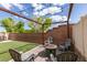 Cozy backyard with a brick fire pit and chairs under a string-lit pergola at 5023 Salt River Ave, Las Vegas, NV 89139