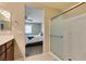 Bathroom featuring a wood cabinet and tiled shower with glass doors at 5023 Salt River Ave, Las Vegas, NV 89139