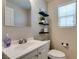 Cozy bathroom with floating shelves, creating a serene and organized space at 5023 Salt River Ave, Las Vegas, NV 89139
