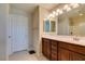 Well-lit bathroom with double mirrors, a wood cabinet, and tile flooring at 5023 Salt River Ave, Las Vegas, NV 89139