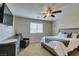 A well-lit bedroom offers a comfortable bed, soft carpet, and fan at 5023 Salt River Ave, Las Vegas, NV 89139
