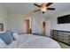 Bedroom featuring a ceiling fan, TV, and access to the bathroom and laundry room at 5023 Salt River Ave, Las Vegas, NV 89139