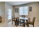 Cozy dining area near the door and window, featuring wood table with chairs and bench seating at 5023 Salt River Ave, Las Vegas, NV 89139