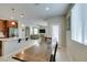 View of the dining table and kitchen with stainless steel appliances and granite countertops, perfect for Gathering meals at 5023 Salt River Ave, Las Vegas, NV 89139