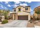 Two-story home features a two-car garage, neutral stucco, stone accents, and manicured landscaping at 5023 Salt River Ave, Las Vegas, NV 89139