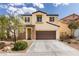 Two-story home features a two-car garage, neutral stucco, stone accents, and manicured landscaping at 5023 Salt River Ave, Las Vegas, NV 89139