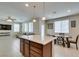 Modern kitchen featuring a central island with granite countertops and adjacent living space at 5023 Salt River Ave, Las Vegas, NV 89139