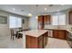 Bright kitchen with stainless steel appliances, granite countertops, island and adjacent dining table at 5023 Salt River Ave, Las Vegas, NV 89139