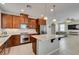 A modern kitchen features stainless steel appliances, granite countertops, and a central island for cooking and entertaining at 5023 Salt River Ave, Las Vegas, NV 89139