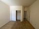 A standard empty bedroom featuring neutral carpeting, white walls, and a closet at 5147 Progresso St, Las Vegas, NV 89135