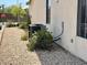 Exterior side view of home with rocks and foliage surrounding air conditioning unit at 5147 Progresso St, Las Vegas, NV 89135