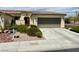 Inviting single-story home featuring a well-manicured yard and an attached two-car garage at 5147 Progresso St, Las Vegas, NV 89135