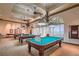 This game room has several beautiful pool tables and ornate lighting fixtures that create a fun social space at 5147 Progresso St, Las Vegas, NV 89135