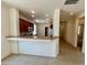 A kitchen and breakfast bar area with tile floors and recessed lighting at 5147 Progresso St, Las Vegas, NV 89135