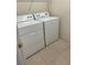 Laundry room features a white washer and dryer with tile floors at 5147 Progresso St, Las Vegas, NV 89135