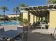 Resort-style pool area featuring covered seating areas, lounge chairs, and lush landscaping at 5147 Progresso St, Las Vegas, NV 89135