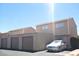 Two-story townhouse with three garages and a car parked out front on a sunny day at 5155 Gray Ln, Las Vegas, NV 89119