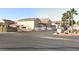 Exterior shot of complex buildings, entry monument, and a landscaped corner at 5155 Gray Ln, Las Vegas, NV 89119