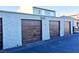 Three garages with brown doors are displayed with the address 5155 on the middle garage at 5155 Gray Ln, Las Vegas, NV 89119
