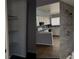 Interior of a home featuring a closet, kitchen with white cabinetry, and a bathroom with gray tiling at 5155 Gray Ln, Las Vegas, NV 89119