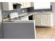 Bright kitchen features white cabinetry, tiled backsplash, sleek countertops, and modern appliances at 5155 Gray Ln, Las Vegas, NV 89119