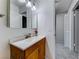 Bathroom with a wood vanity, white countertop, and a view towards the hallway at 5199 Caliente St # 63, Las Vegas, NV 89119