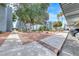 Apartment complex exterior featuring a common area with trees, bushes, and plants at 5199 Caliente St # 63, Las Vegas, NV 89119