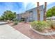 A condo with a stucco exterior, desert landscaping, mature trees and a sidewalk at 5199 Caliente St # 63, Las Vegas, NV 89119