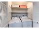 Laundry area equipped with a washing machine, dryer, and overhead shelving at 5199 Caliente St # 63, Las Vegas, NV 89119