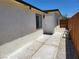Side of house with gravel and concrete walkway and partial view of fenced backyard at 532 N 9Th St, Las Vegas, NV 89101