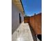 Concrete walkway leading to fenced backyard and side of home at 532 N 9Th St, Las Vegas, NV 89101