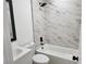 Bathroom featuring a tub with white marble tile and black hardware at 532 N 9Th St, Las Vegas, NV 89101