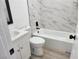 Bathroom featuring a bathtub with white marble tile and black hardware at 532 N 9Th St, Las Vegas, NV 89101