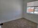 Neutral carpeted bedroom featuring a bright window with a view to the neighborhood at 532 N 9Th St, Las Vegas, NV 89101
