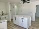 Open kitchen features a center island, sleek white cabinetry, and modern finishes at 532 N 9Th St, Las Vegas, NV 89101