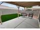 Covered patio with seating in landscaped backyard at 5824 Red Gull St, Las Vegas, NV 89149