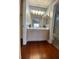Well-lit bathroom with a double sink vanity and wood flooring for a warm and inviting feel at 5824 Red Gull St, Las Vegas, NV 89149